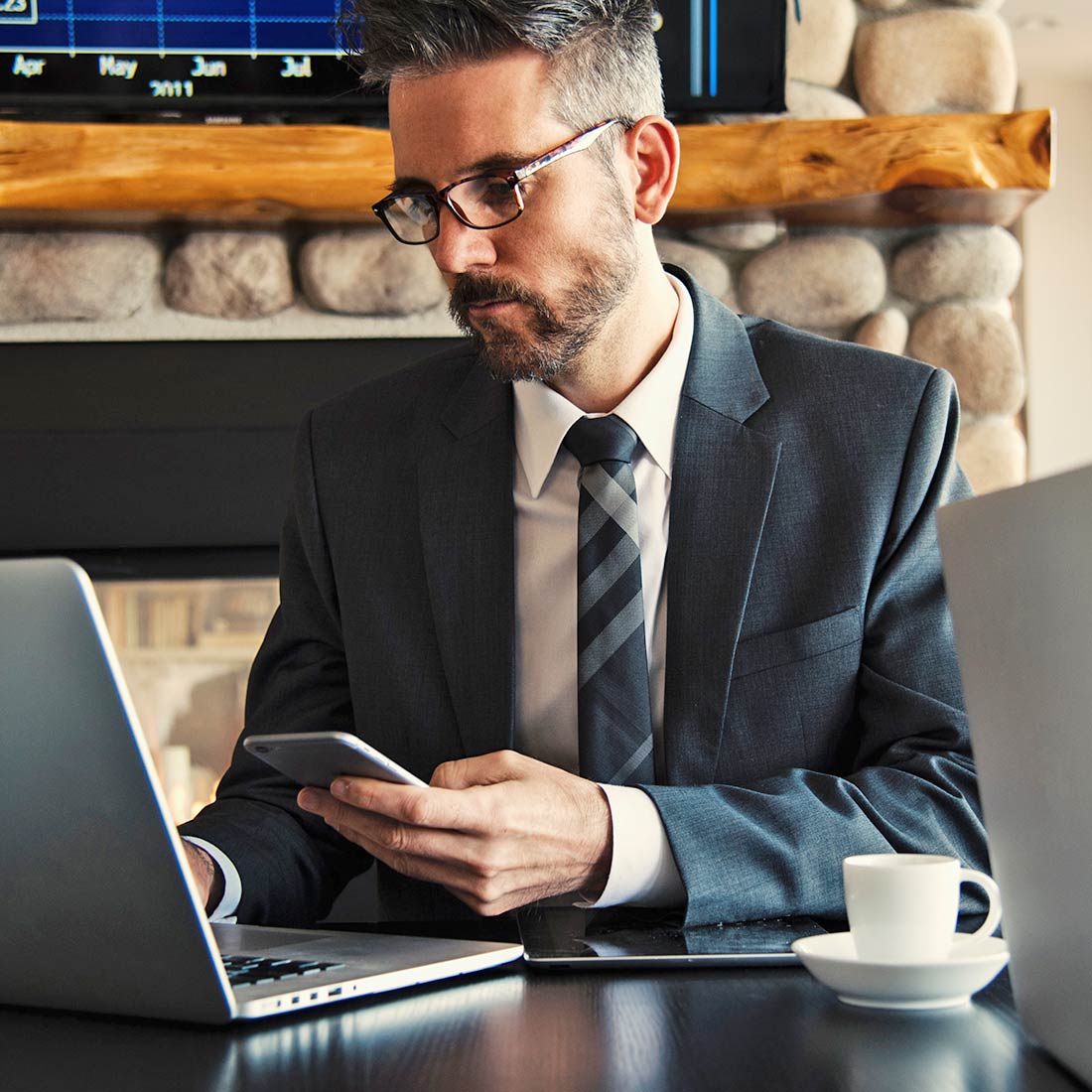 Man Working on Phone and Laptop Man Working on Phone and Laptop